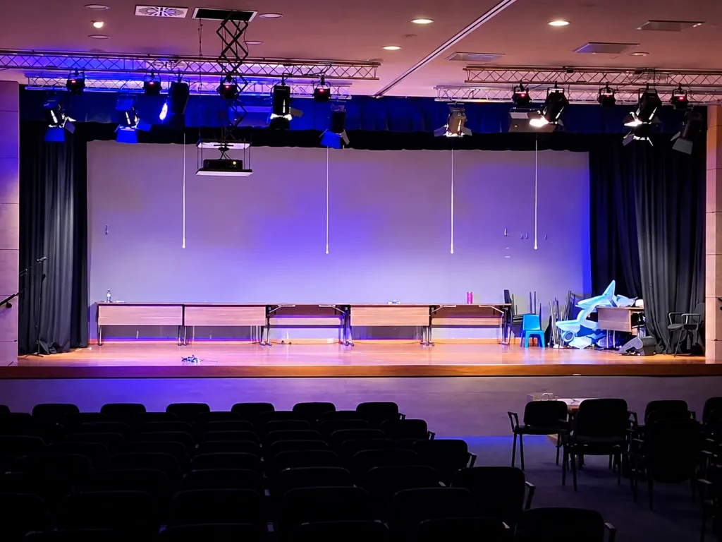 POED auditorium stage in Nicosia with professional audio and stage lighting