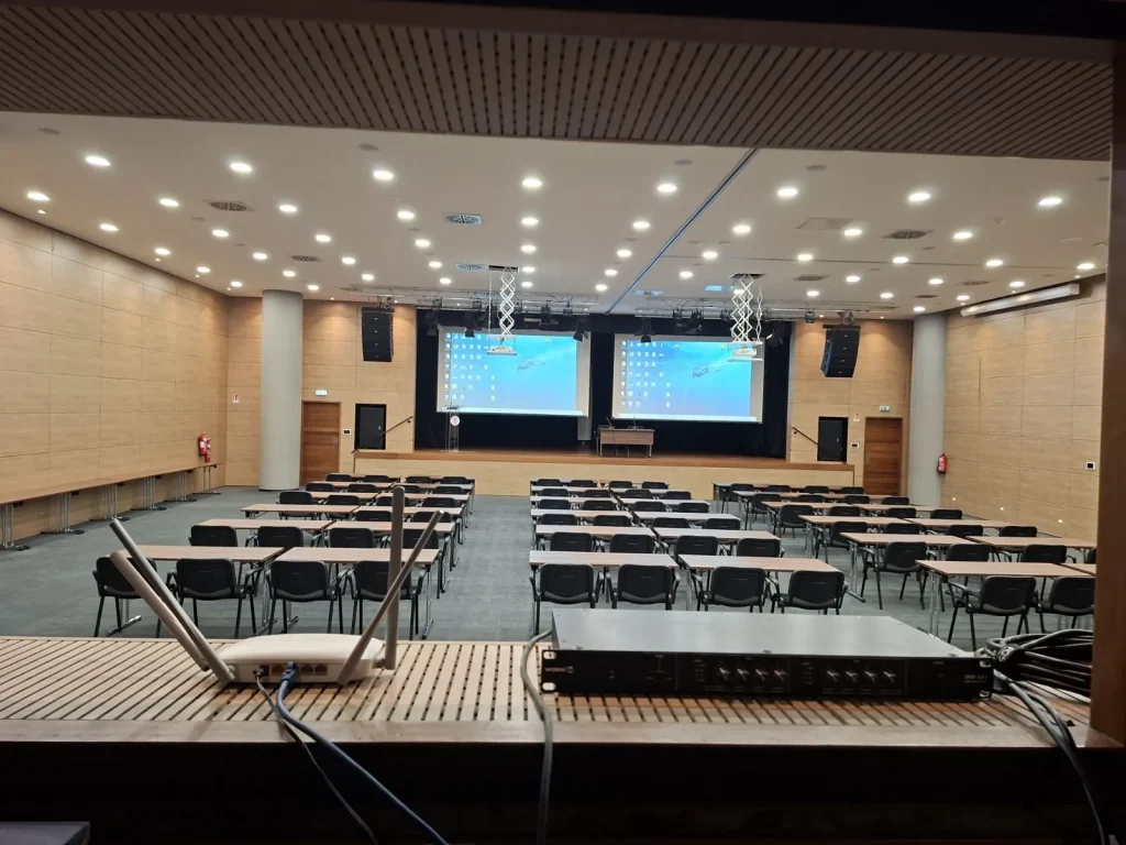 POED conference hall in Nicosia with suspended line array speakers and projection screens