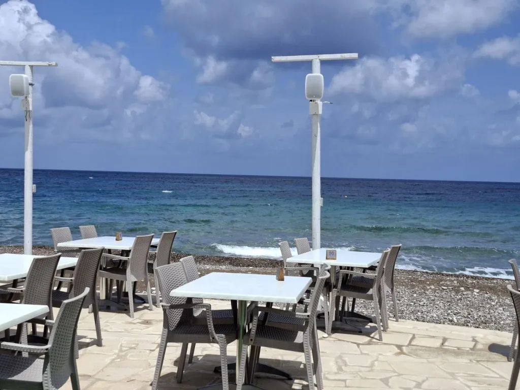 Beachfront dining area at S.K. Yiallos Beach Kebab with outdoor speakers