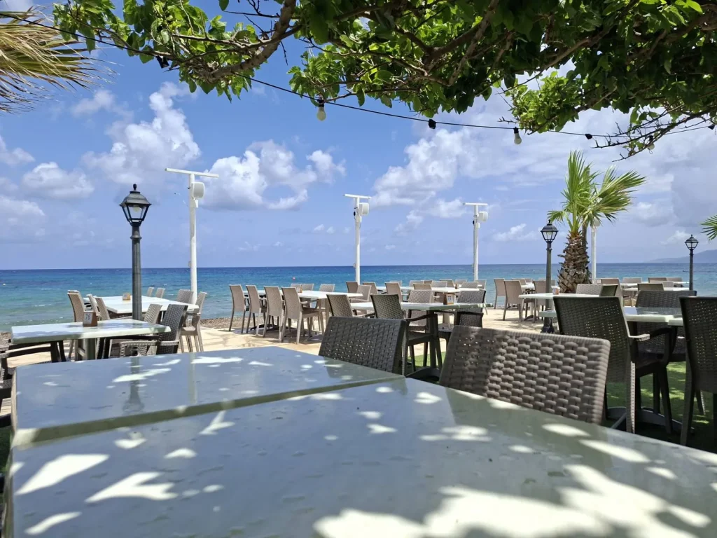 Seaside terrace at S.K. Yiallos Beach Kebab with speaker poles